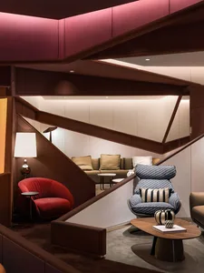 An industrial-style living room with metal accents and a mix of modern and vintage furniture.