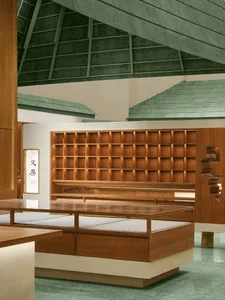 A minimalist calligraphy room featuring wooden furniture and shelves.