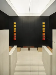 Modern retail storefront featuring a minimalist design with concrete and glass materials.
