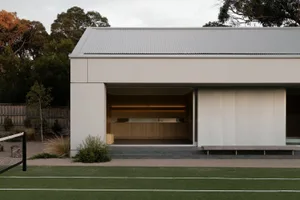 A modern residential house with a concrete and glass exterior.