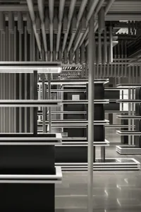 Empty minimalist retail store interior with black and white metal shelves and wooden accents.
