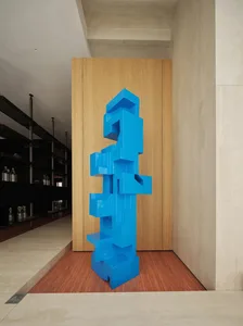 A minimalist, blue metal sculpture in an interior space.