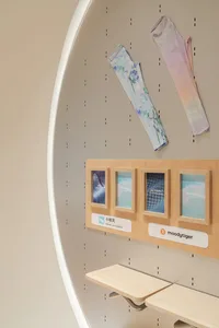 A modern retail interior displaying accessories with a wooden display board and two hanging arm sleeves.