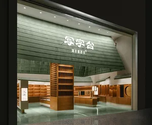 A modern retail storefront with wooden furniture and green flooring.