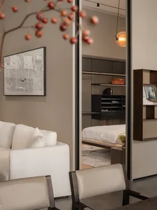 Modern bedroom featuring sleek, neutral-toned furniture and a minimalist design