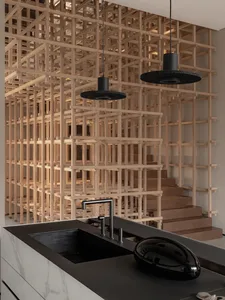 Modern kitchen interior featuring a black countertop and white marble backsplash.