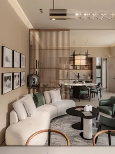 Contemporary living room featuring plush fabric sofas, wooden accents, marble surfaces, and a sleek metal lamp