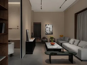 A modern living room featuring neutral-colored furniture and decor, with a focus on minimalist design.