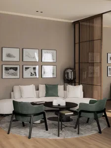 A modern minimalist living room featuring a white L-shaped sofa, green accent chairs, and a round coffee table with a minimal