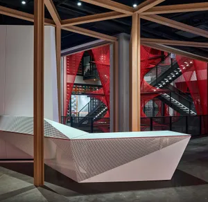 A modern reception desk made of perforated metal material.