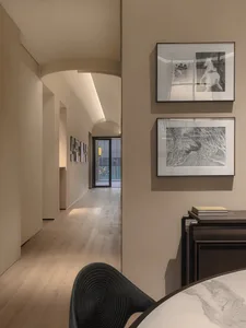 A modern interior space with wooden flooring and light fixtures.