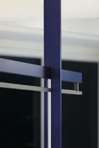 A minimalist architectural structure featuring metallic and glass components.