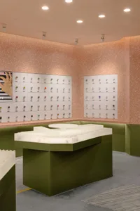 A modern jewelry shop display with terrazzo surfaces and a variety of jewelry items.