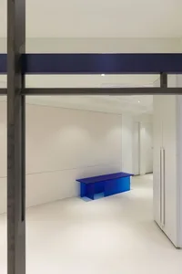 Modern office interior with a sleek, minimalist desk and white background.