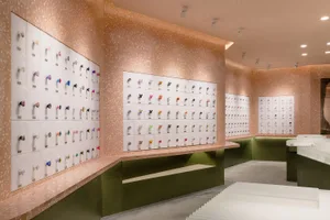 A retail store with a terrazzo display wall showcasing various colorful products.