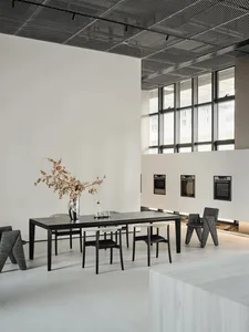 Modern commercial space with white concrete floors, glass windows, and minimalist design.
