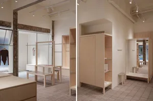 Retail shop interior showcasing minimalist design with wooden furniture and glass elements.