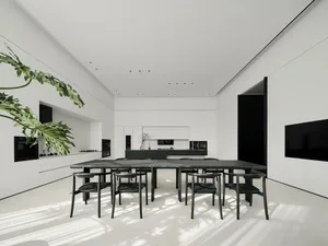 Modern living room with concrete flooring and minimalist furniture.