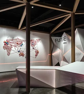A modern exhibition space featuring geometric shapes and metallic elements.