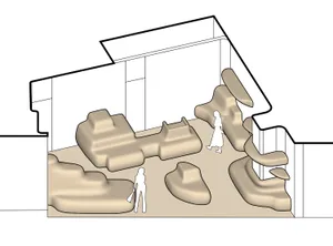 A modern playground area with sand mounds and pathways.