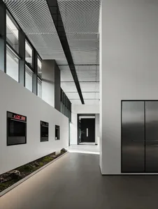 Modern residential interior with industrial design elements, featuring metal materials and a minimalist aesthetic.