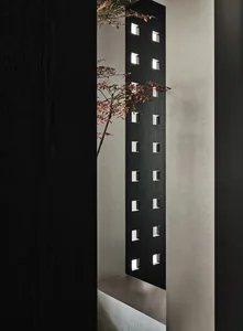 Close-up of a modern architectural feature with black perforated screen.