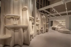 A modern retail shop with smooth, sculptural concrete forms and minimalist lighting.