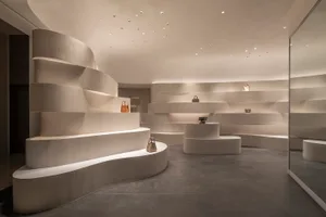 Modern retail store interior featuring minimalist design with concrete elements