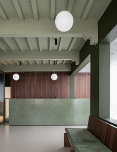 Modern, minimalist office lobby featuring a sleek, concrete reception desk.
