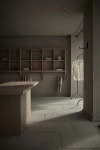 A minimalist wardrobe space featuring wooden shelves and hanging clothes.