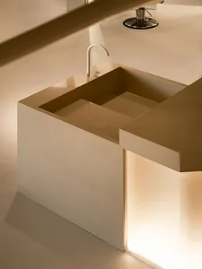 Modern minimalist bathroom featuring a concrete sink and countertop with a white faucet.