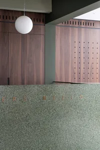 Modern coffee shop interior featuring wood, concrete, and terrazzo materials.