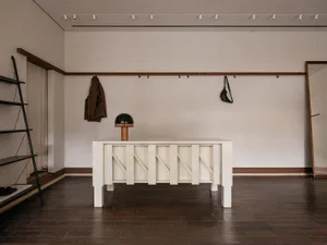 A minimalist entryway featuring a white wooden console table.