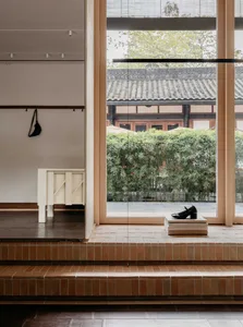 A minimalist storefront featuring a concrete sculpture.