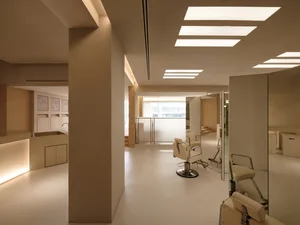 Spa interior with modern, minimalist design featuring glass panels.