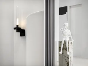 A modern interior design featuring sleek, white lighting fixtures mounted on a white wall.