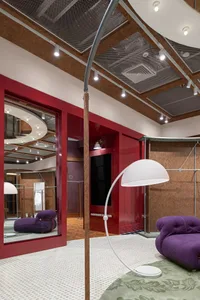 A modern retail storefront featuring sleek glass, metallic accents, and wooden elements.