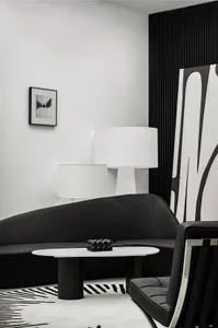 A modern living room with black and white decor and minimalist design.