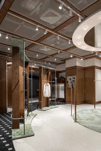A modern retail shop interior featuring a wooden floor and minimalist design.