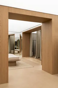 A modern interior design room featuring wooden furniture and flooring.