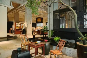 A modern industrial retail shop featuring a mix of concrete and wooden elements.