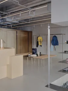 A minimalist retail space with industrial elements, showcasing metal and concrete finishes.