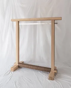A minimalist wooden clothing hanger with a single rod and a textured base.
