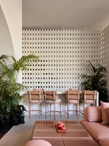 Interior of a modern coffee shop featuring concrete, glass, and wood materials.