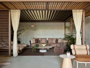 Modern lounge area with concrete furniture and skylight ceiling