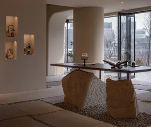 A modern lobby featuring a minimalist design with concrete elements.