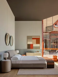 A minimalist bedroom with a modern design featuring a low-profile bed, sleek nightstand, and abstract wall art.
