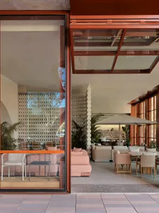 A modern office interior with large glass windows and minimalistic furniture.