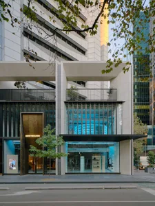 Modern retail storefront featuring glass and concrete materials.
