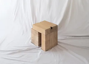 A minimalist wooden stool made from stacked wooden blocks.